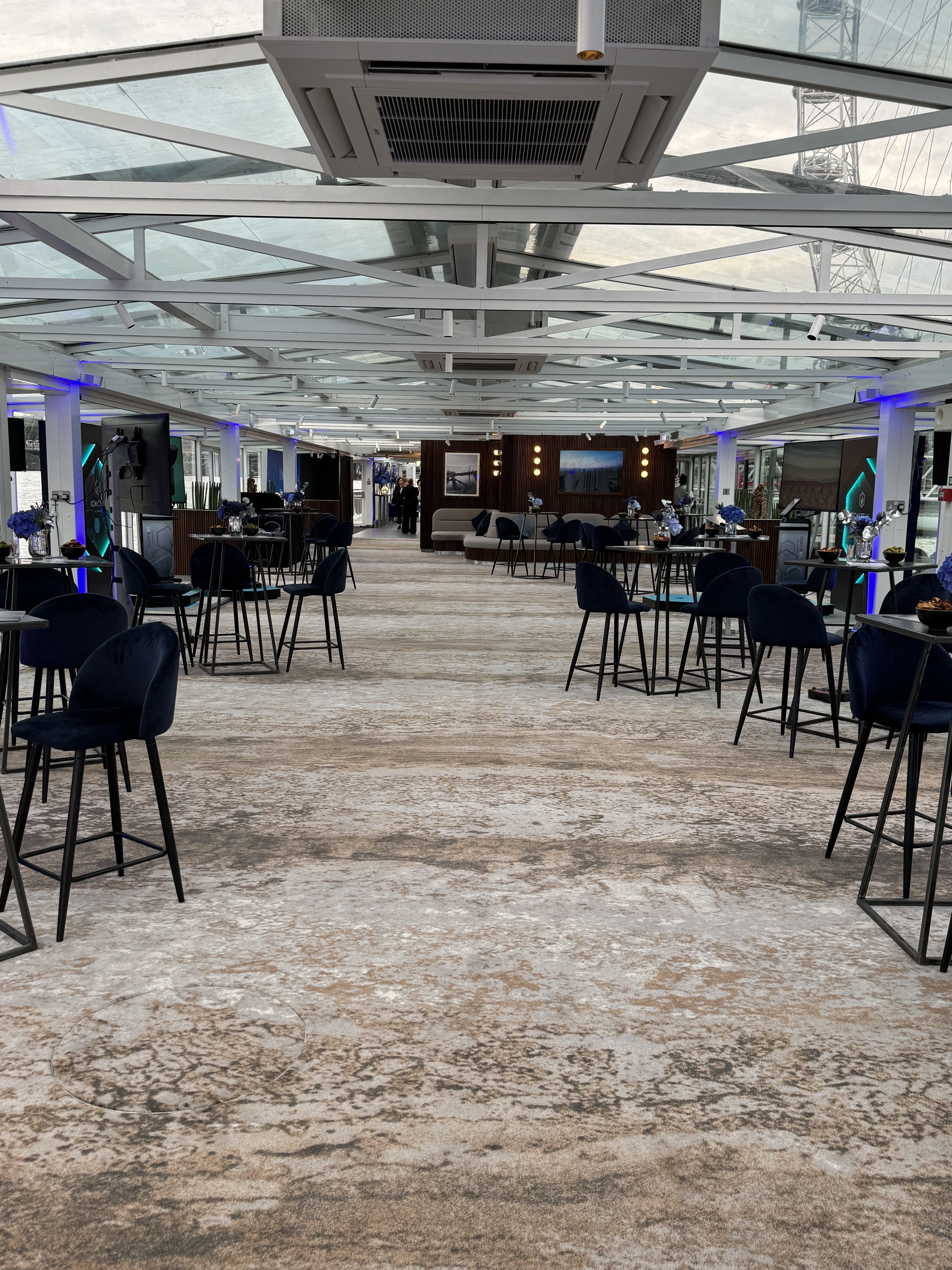 Modern yacht venue, cocktail event, networking, bar-height tables
