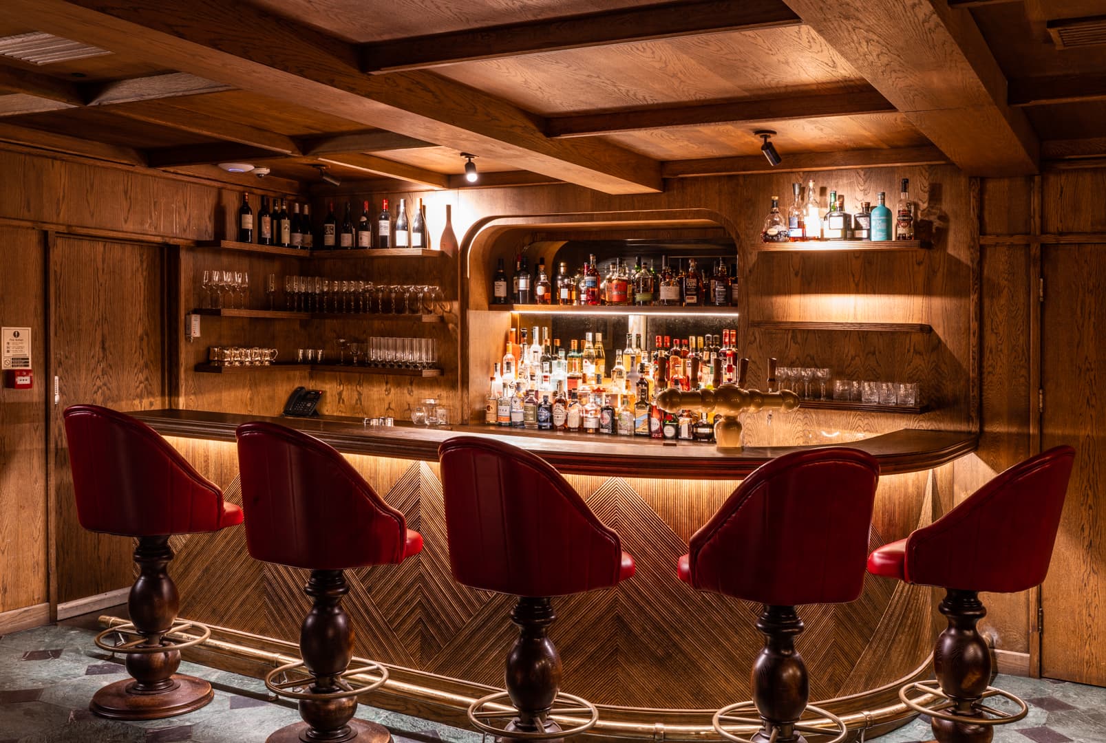 The Clubhouse VIP reception room with iconic red bar seating for private board meetings.