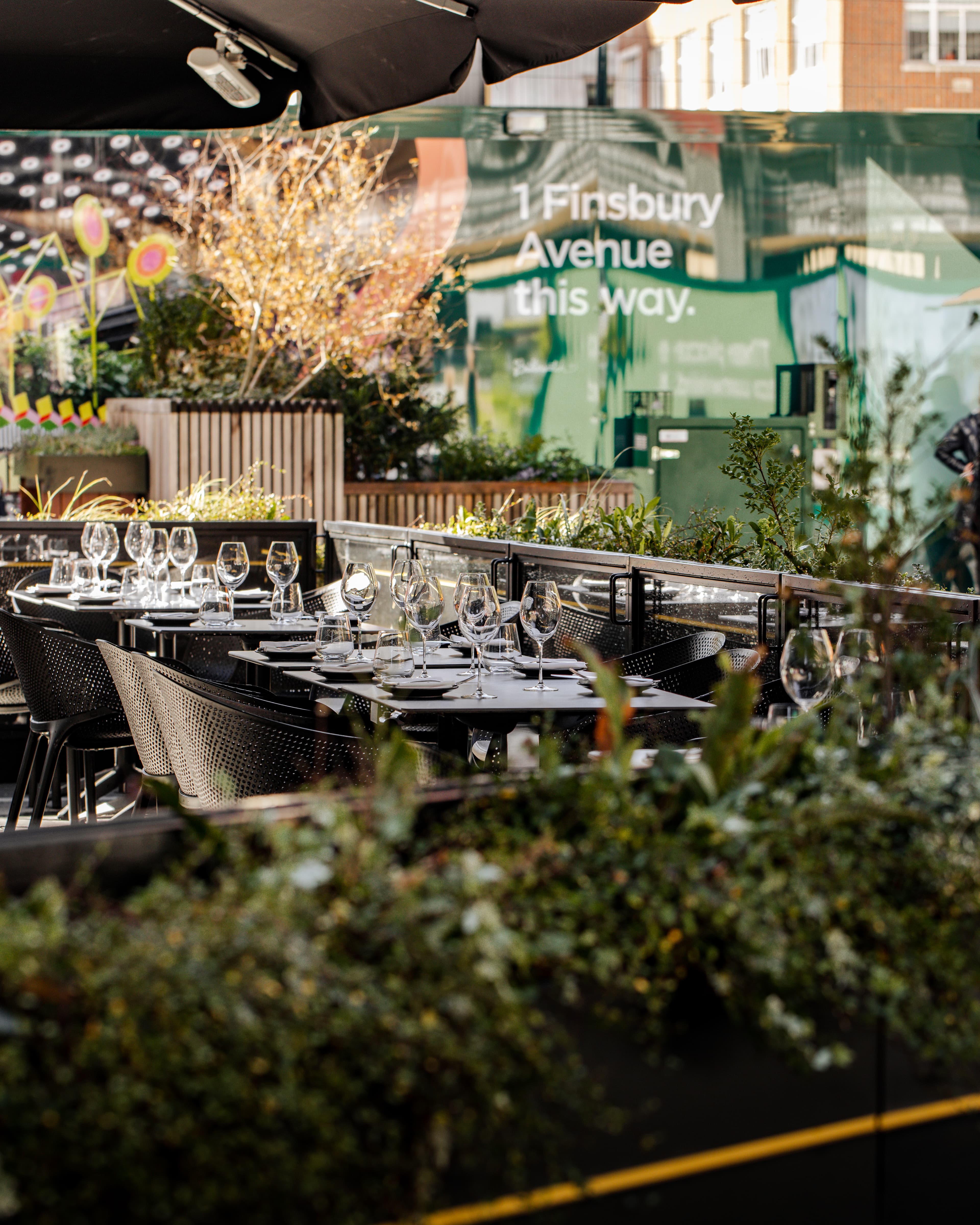 Glasshouse outdoor reception venue, green tables