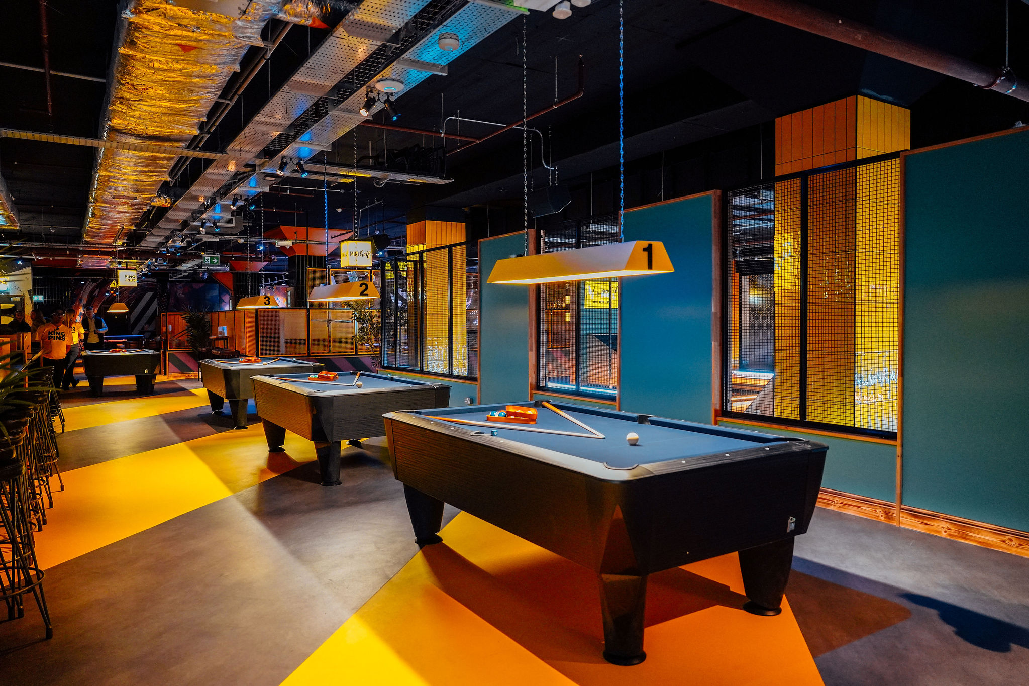Industrial-chic tournament area at King Pins Edinburgh for team-building and networking events.