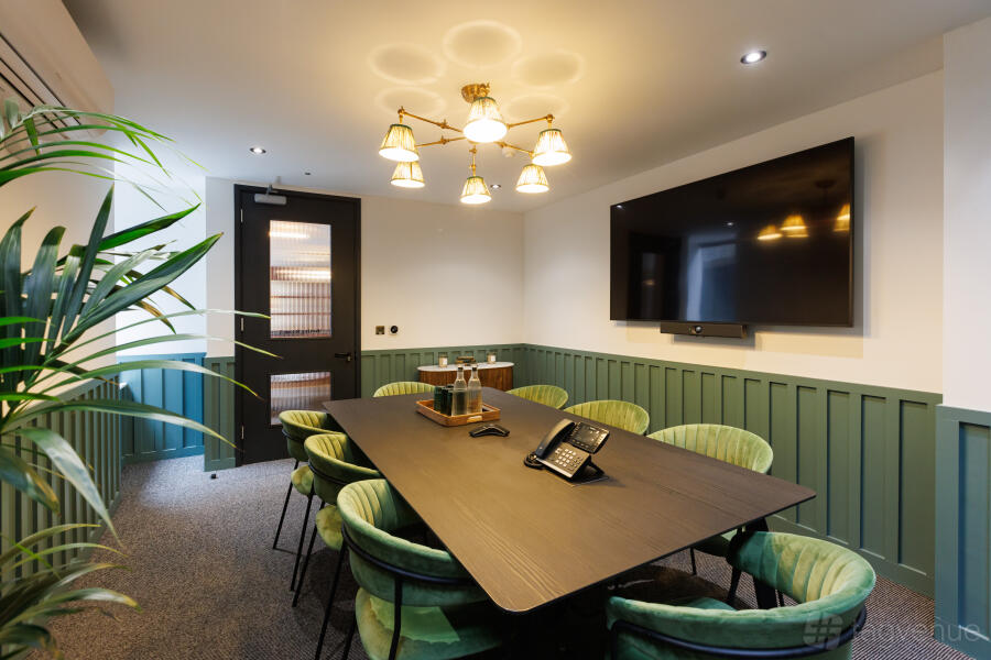 Modern boardroom, green seats, chandelier, executive meeting, hybrid session