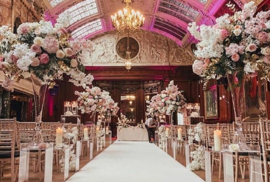Luxury Garden Room wedding ceremony with floral decor at Thornton Manor Country Estate venue.