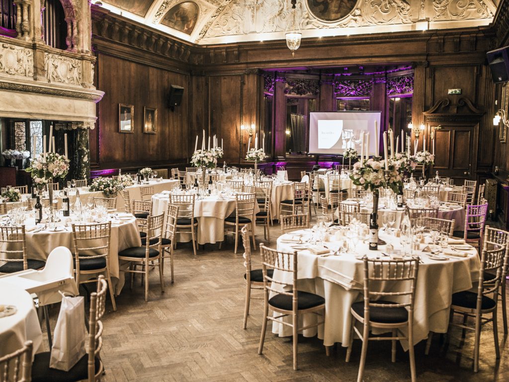 Luxury wedding reception in Thornton Manor Garden Room with gold chairs and floral centerpieces.
