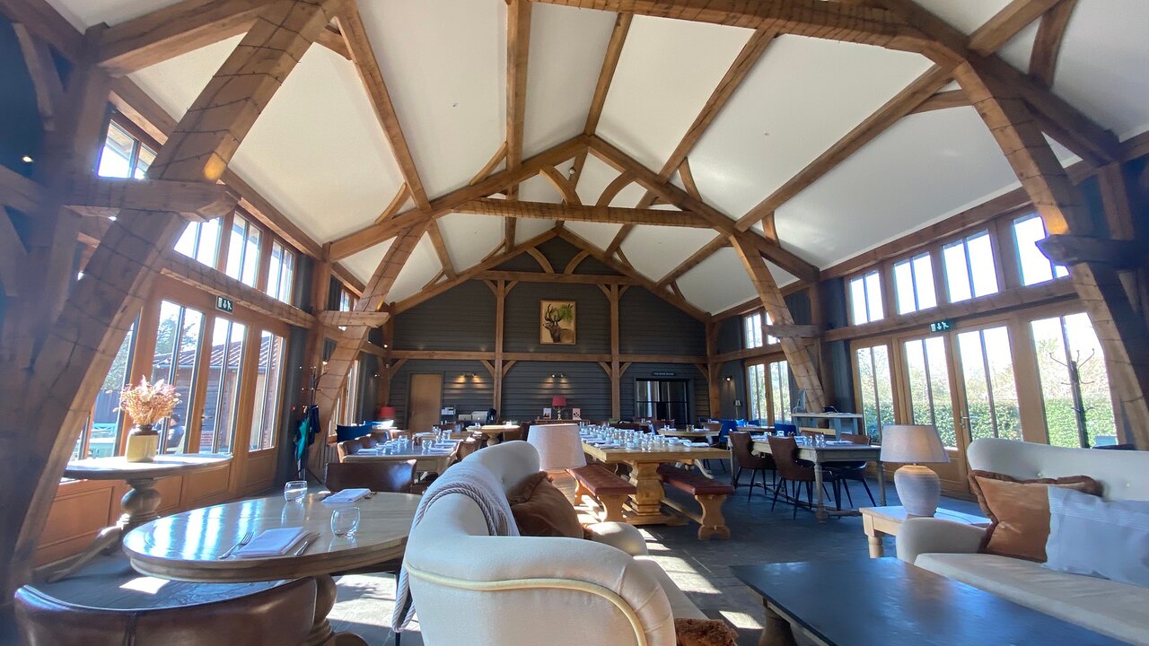 Rustic-chic Main Barn with timber trusses for corporate retreats and dinner events.