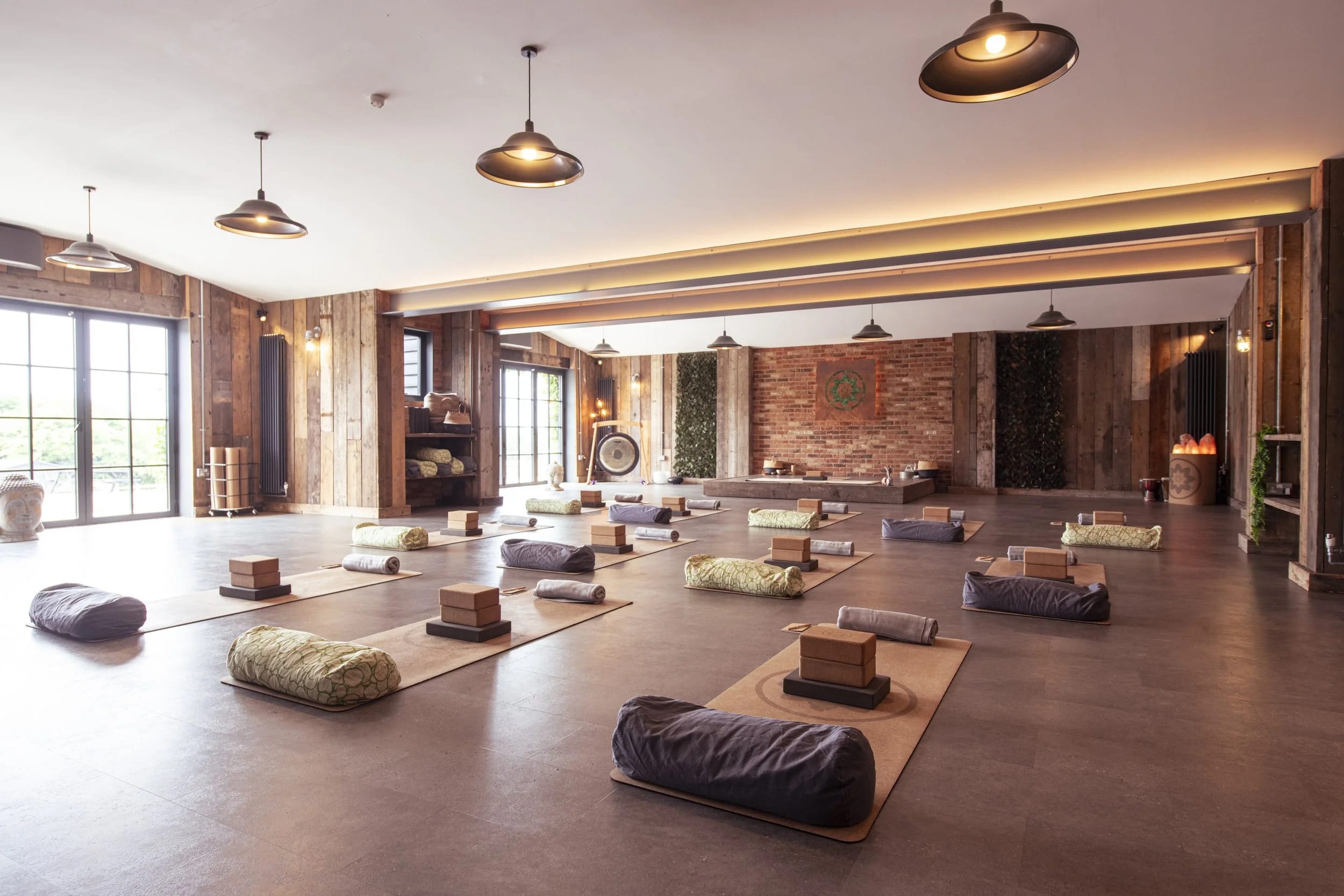 Rustic Main Barn yoga retreat space with floor seating for wellness events and mindfulness workshops.