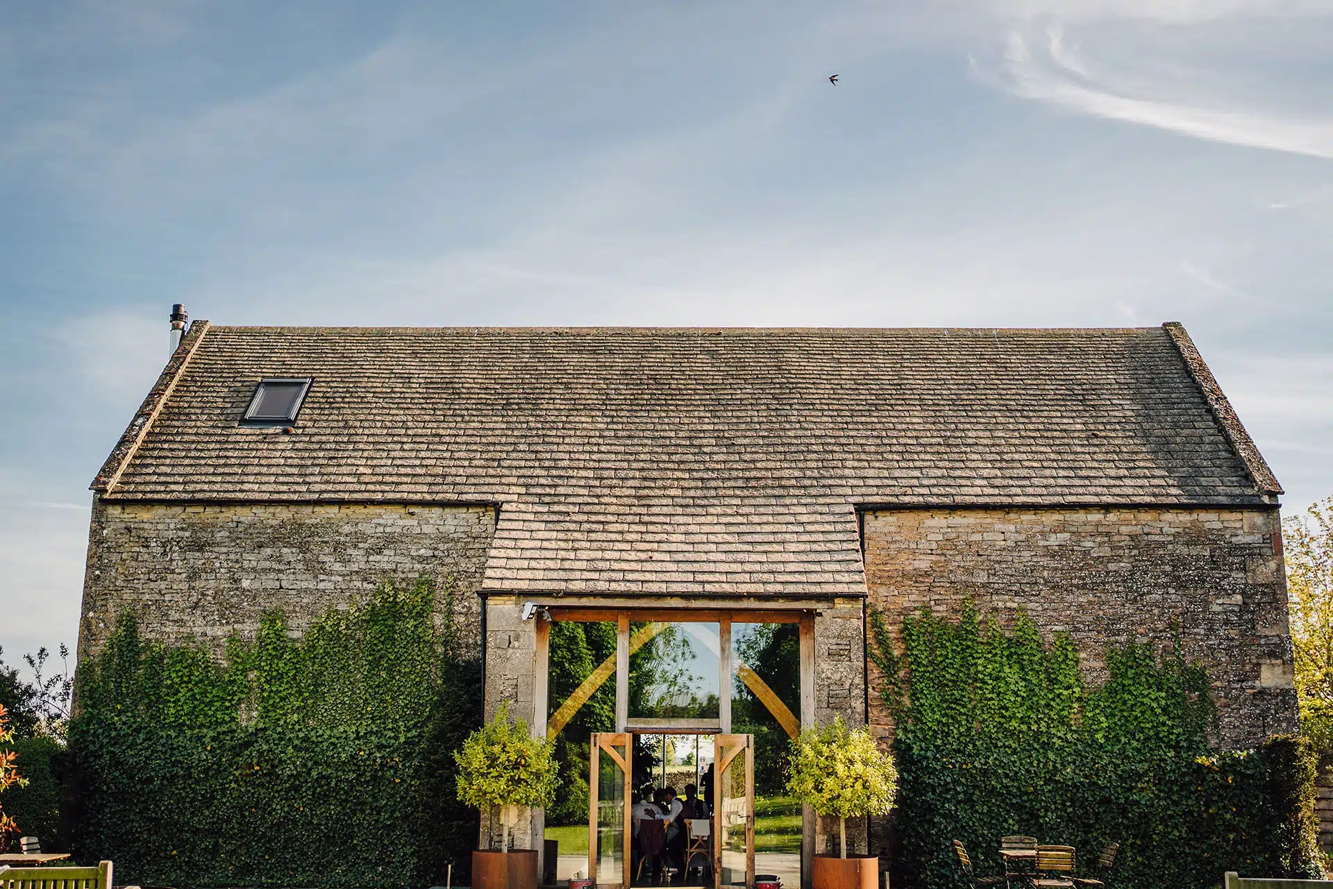 Rustic Main Barn venue for weddings and corporate events with classic farmhouse architecture.