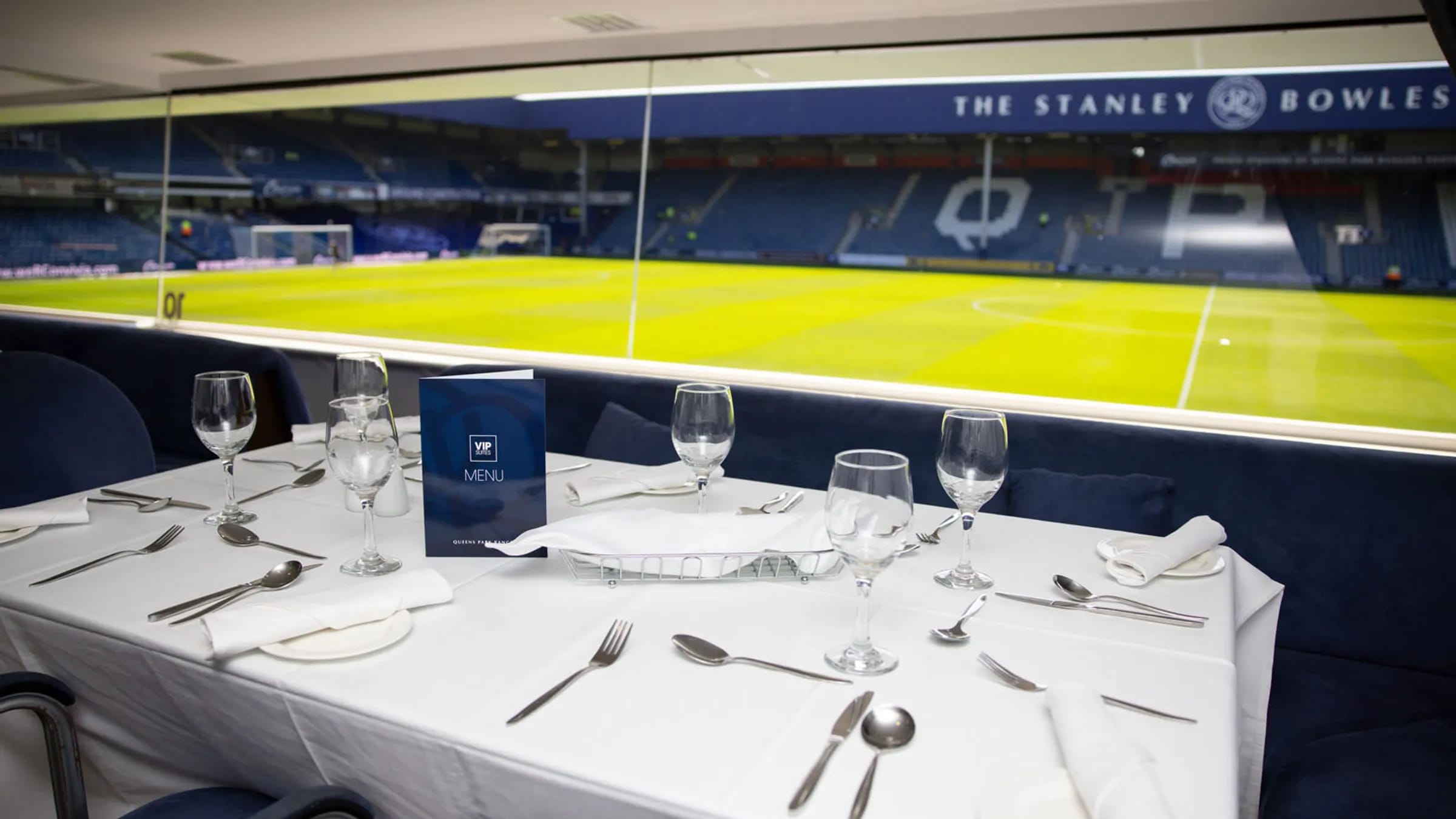 Capital Lounge hospitality suite with pitch-side view at Loftus Road for corporate event venue.