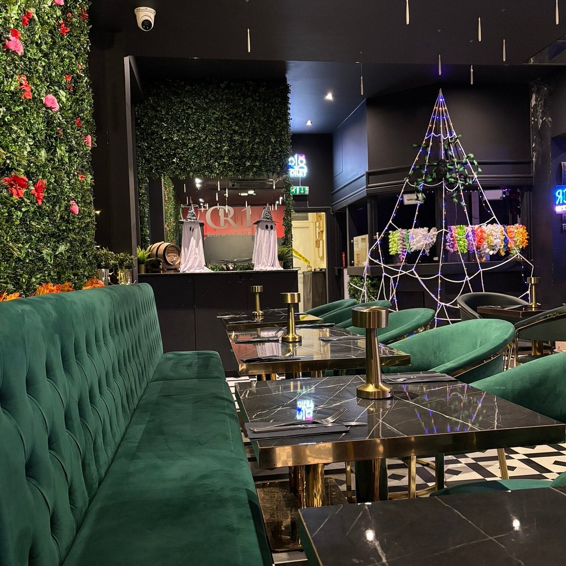 Upscale Leaf Room restaurant interior with spooky Halloween décor for festive events.