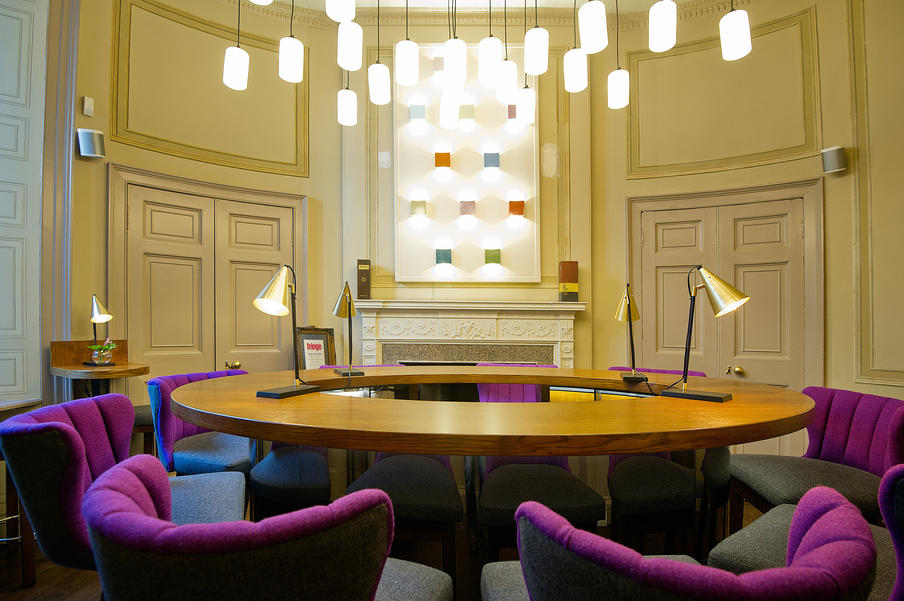 The Oval Room boardroom with purple seating for executive meetings and creative workshops.