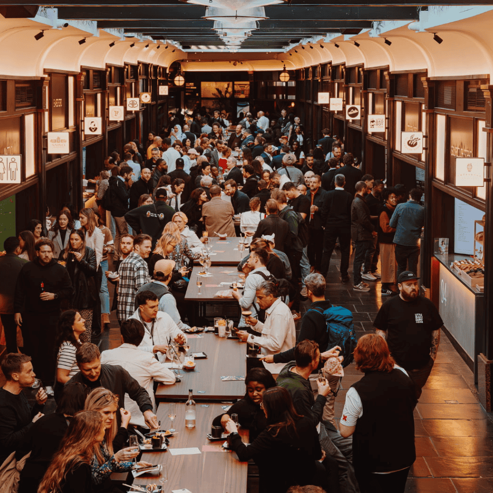 Networking reception in The Ticket Hall at BOXHALL City with long-table communal seating.