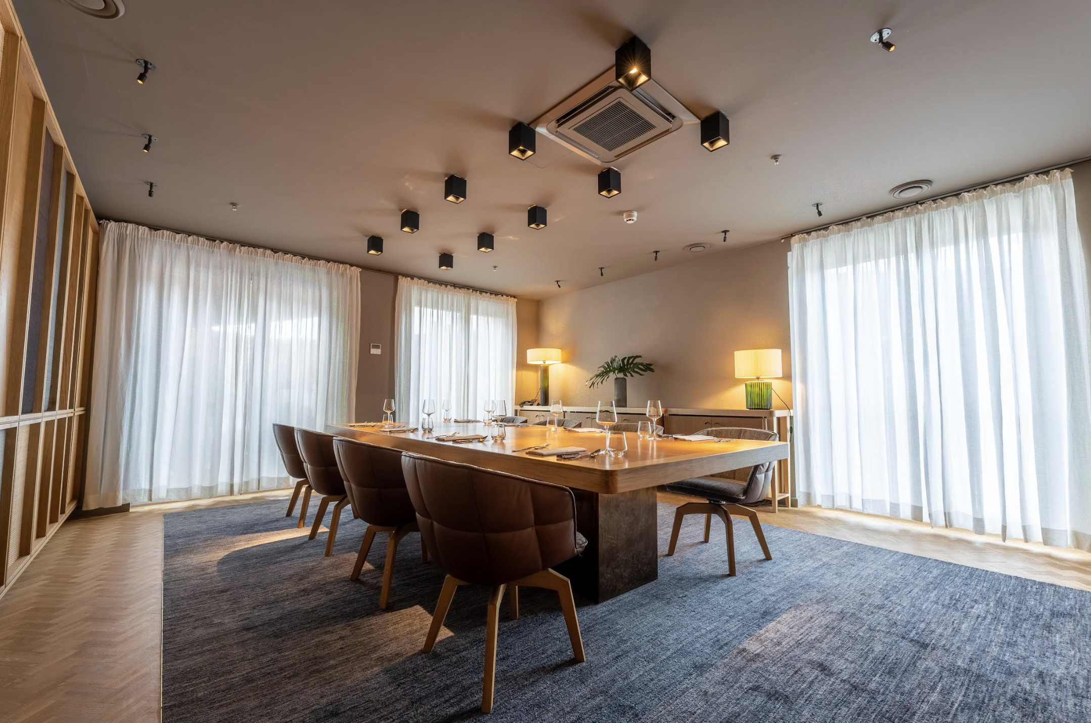 Luxury boardroom with natural light, ideal for executive strategy sessions and private dining.