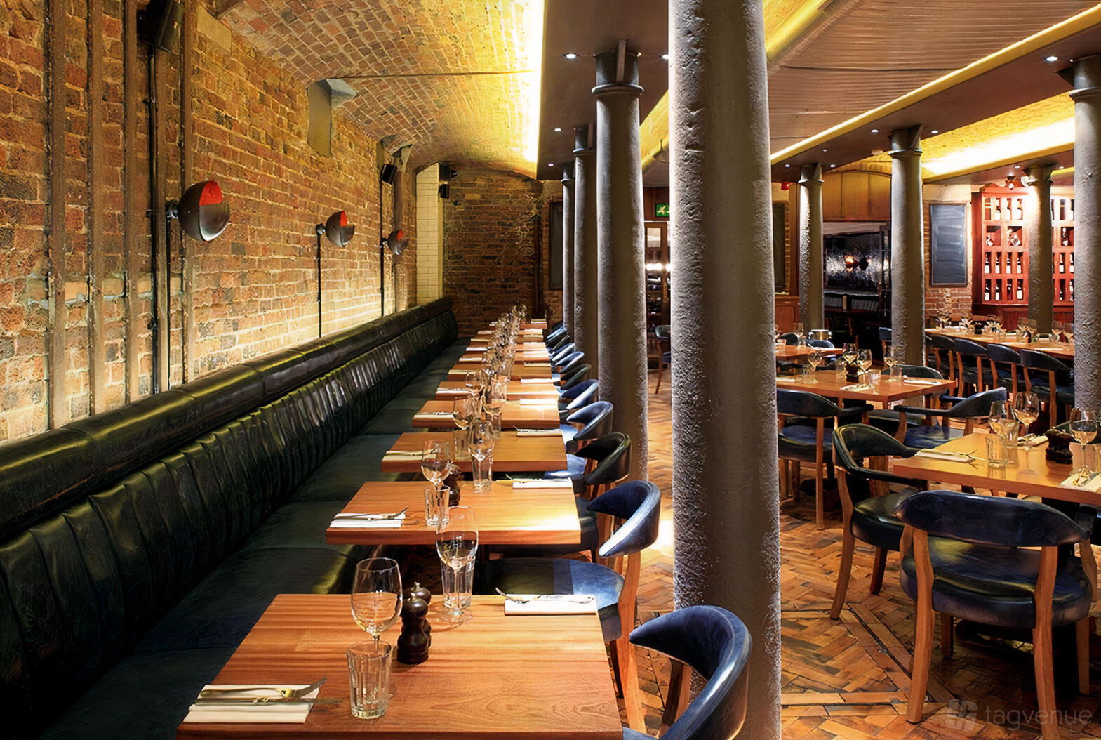 Industrial-chic private dining room with exposed brick for corporate dinners and networking events.