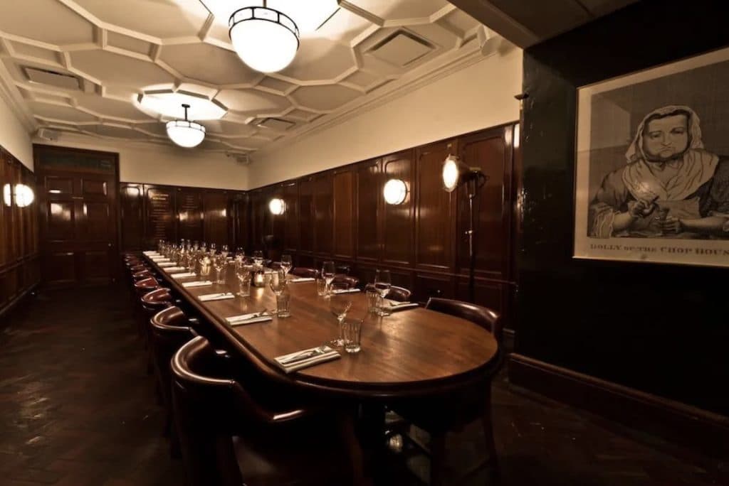 Wood-paneled private dining room at Hawksmoor Seven Dials for VIP corporate dinners and events.