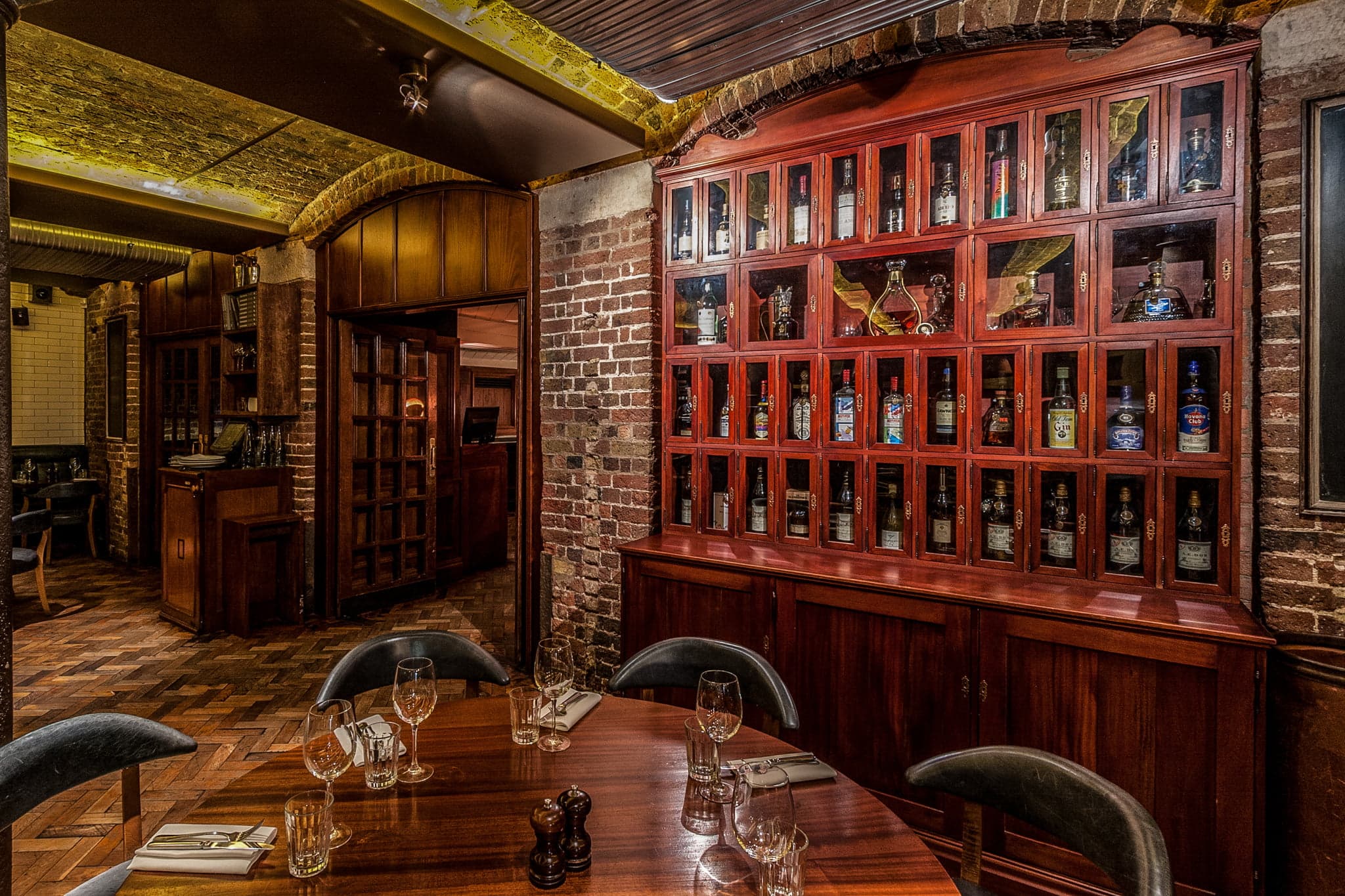 Private dining room at Hawksmoor Seven Dials with wood textures for VIP dinners and board meetings.
