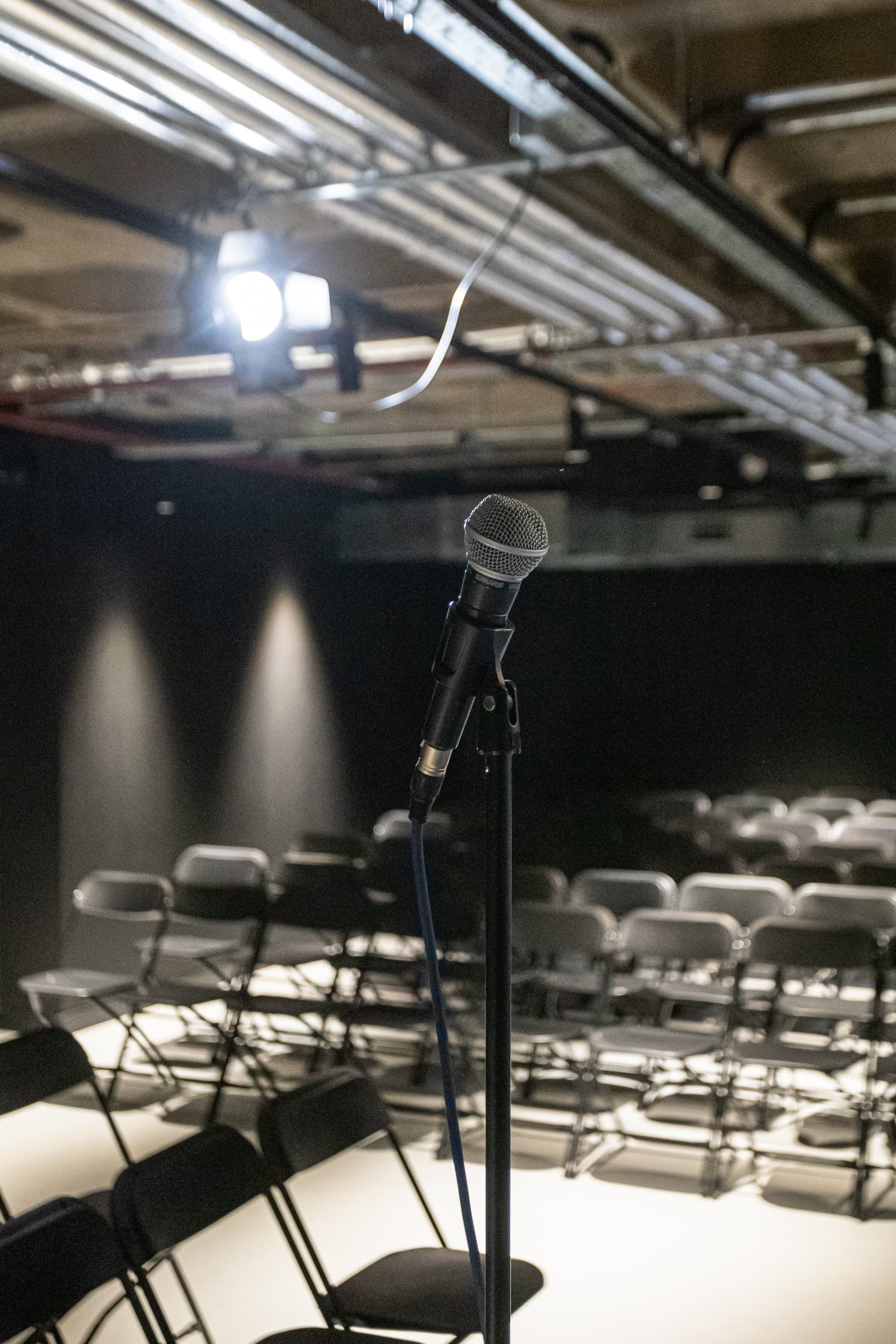 Big Belly Room comedy club stage with microphone for corporate events and keynote presentations.