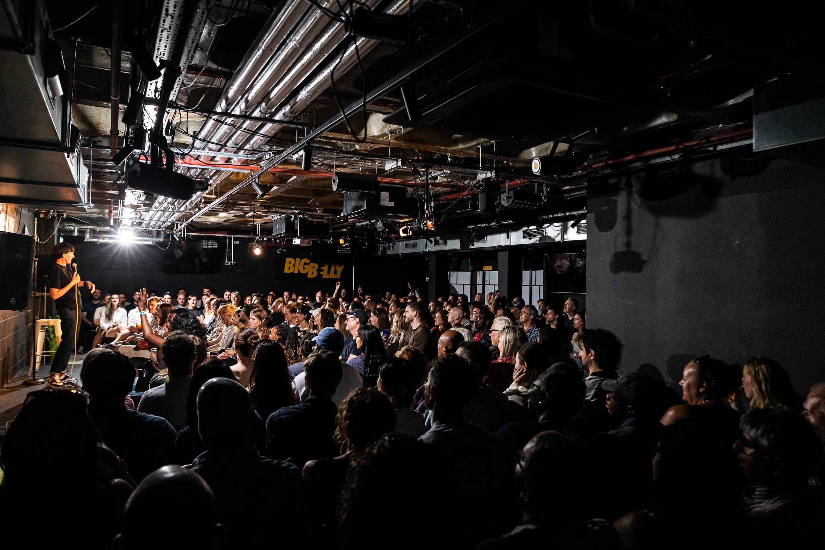 Big Belly Room comedy club stage, industrial-chic venue for live stand-up and comedy events.