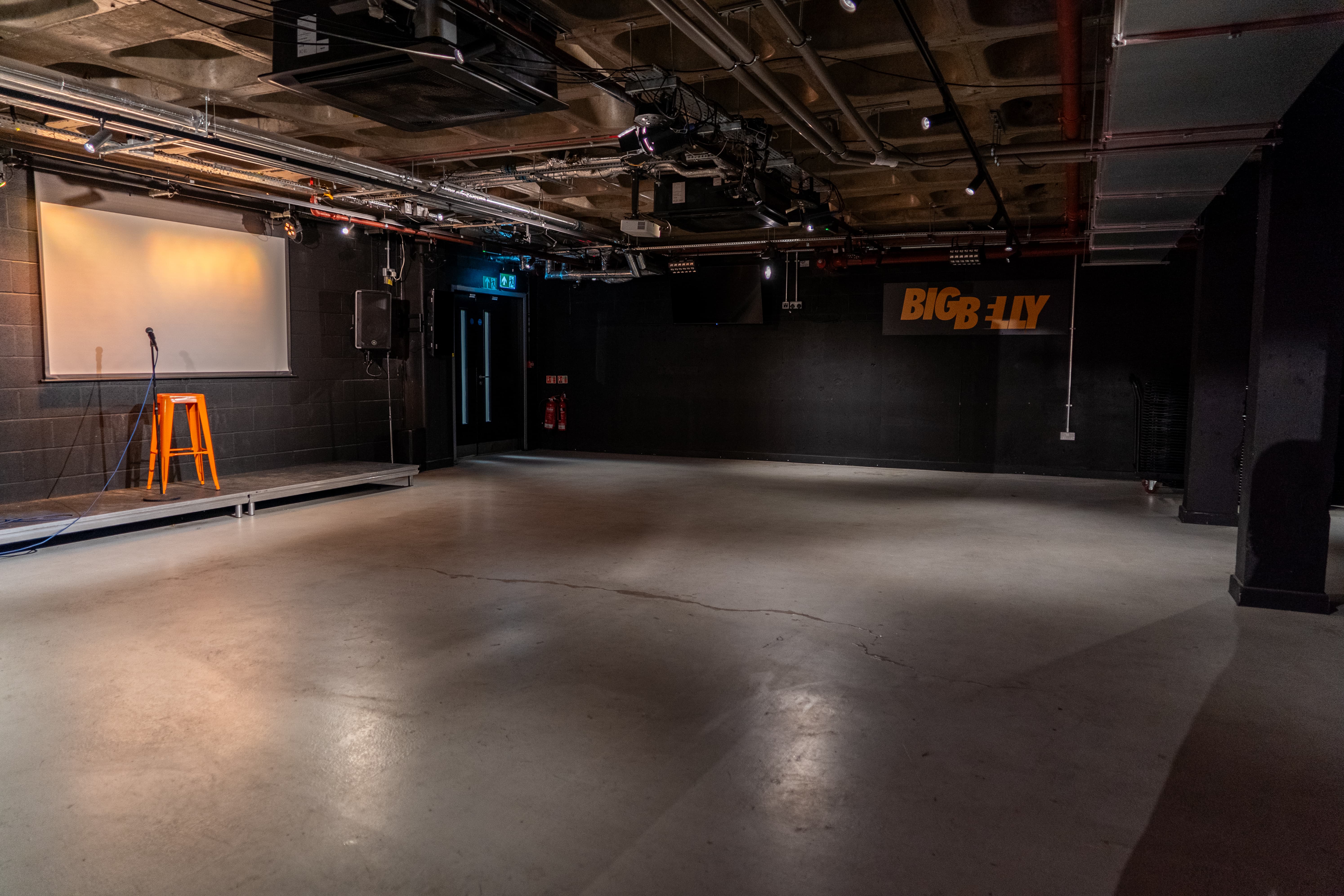 Big Belly Room industrial comedy club venue for intimate sets and creative workshops.