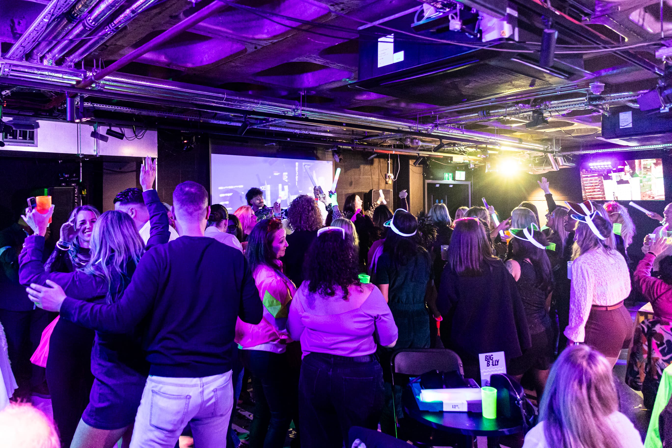Big Belly Room comedy club venue with purple lighting for corporate networking events.