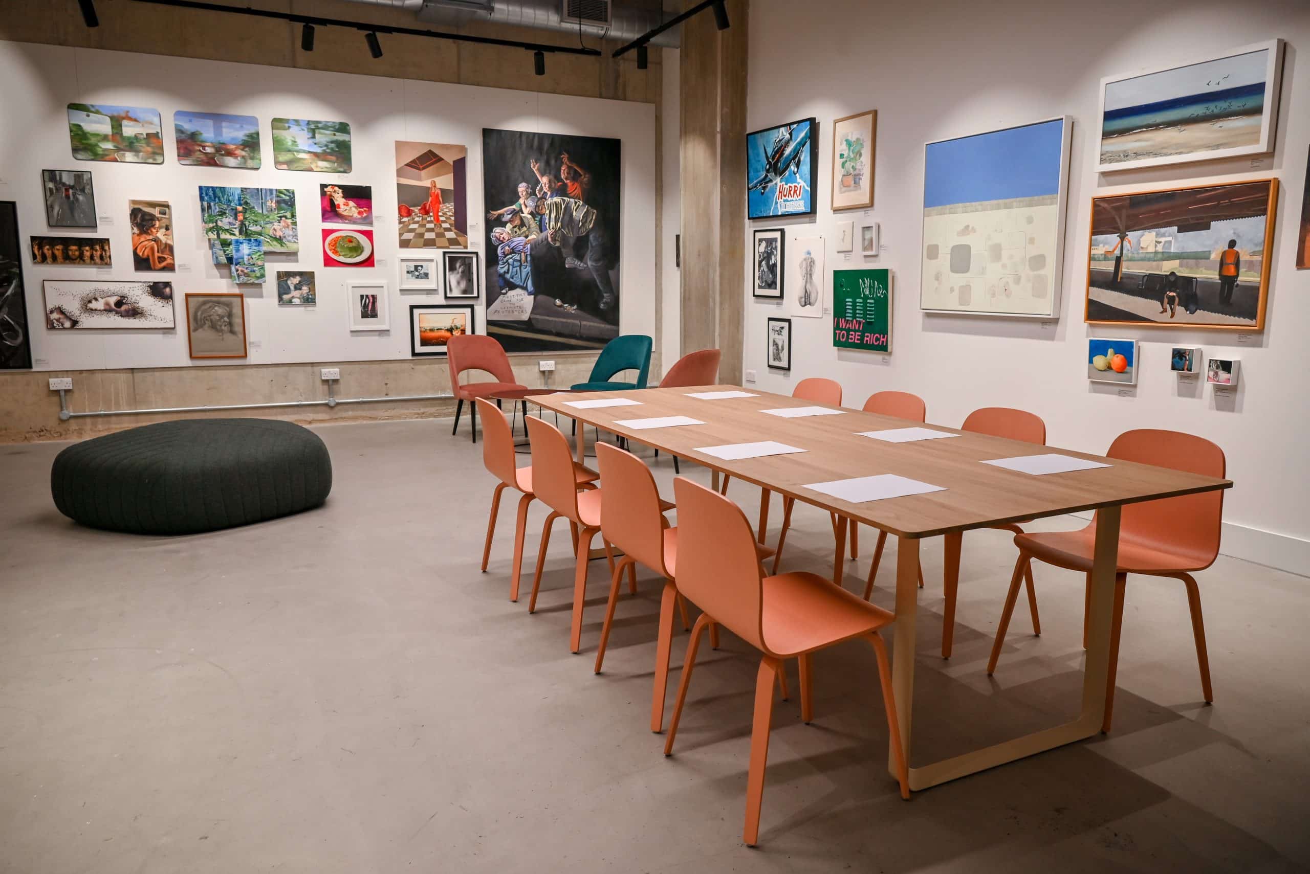 Small-group meeting space in Main Gallery with immersive art backdrop for creative workshops.
