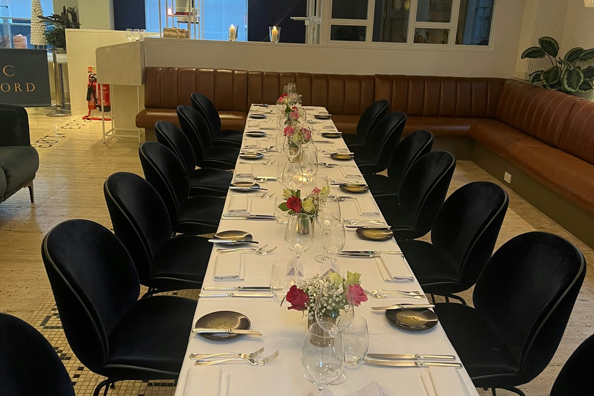 Private dining at CORD Restaurant featuring navy velvet chairs for corporate events.