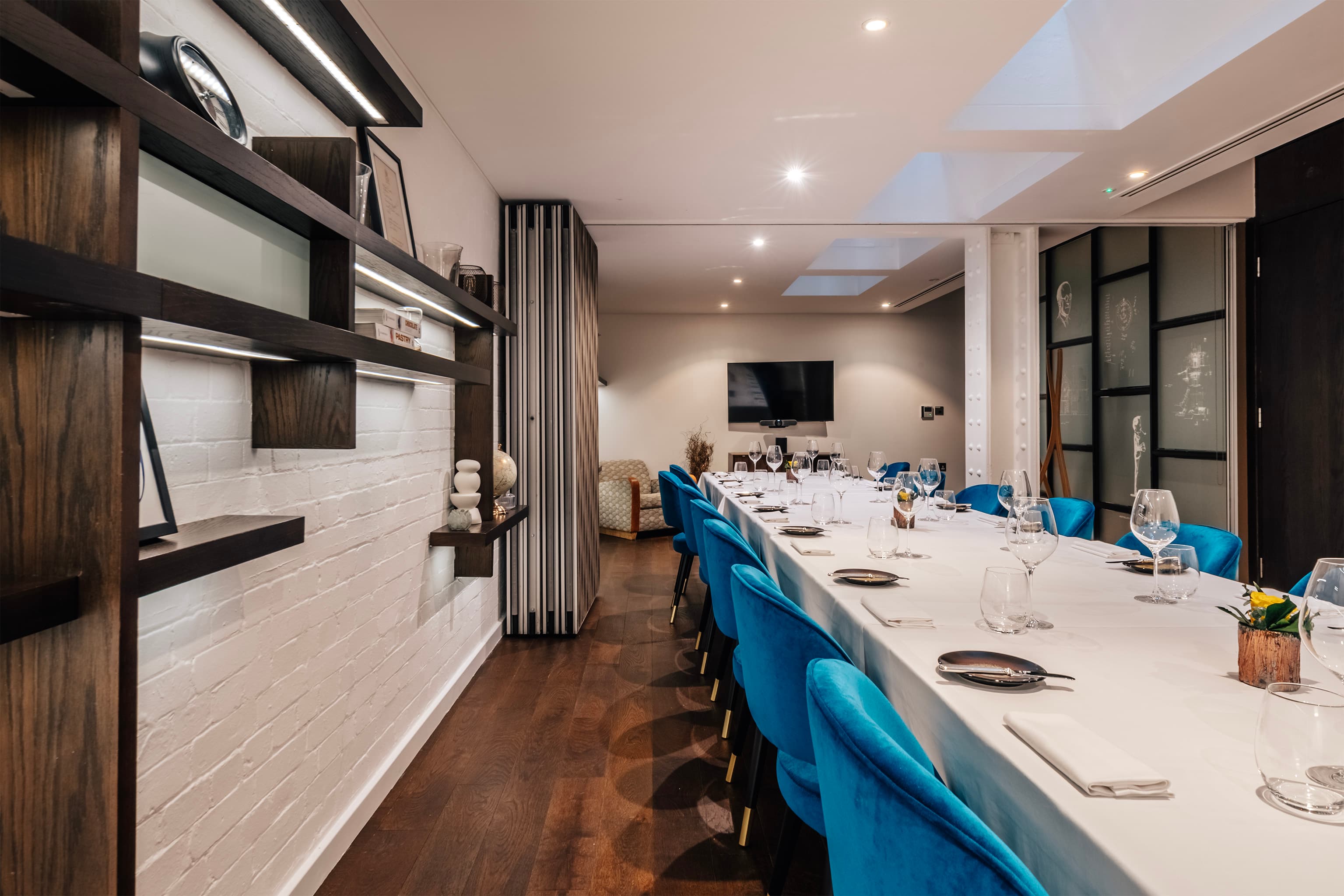 Private dining room with blue chairs for executive offsites and networking events.