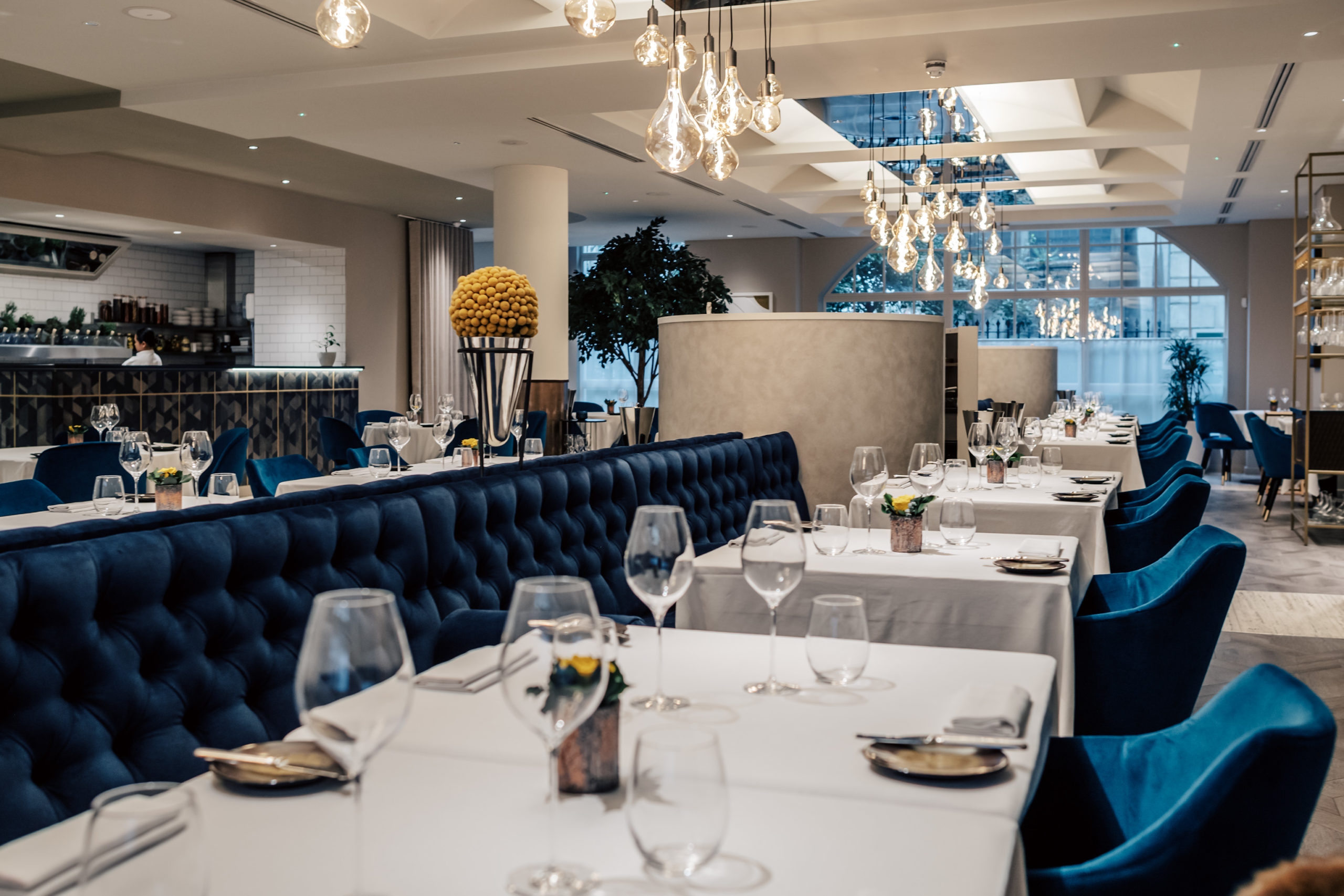 Viceroy at CORD Restaurant: Navy banquette seating for corporate dinners and networking events.