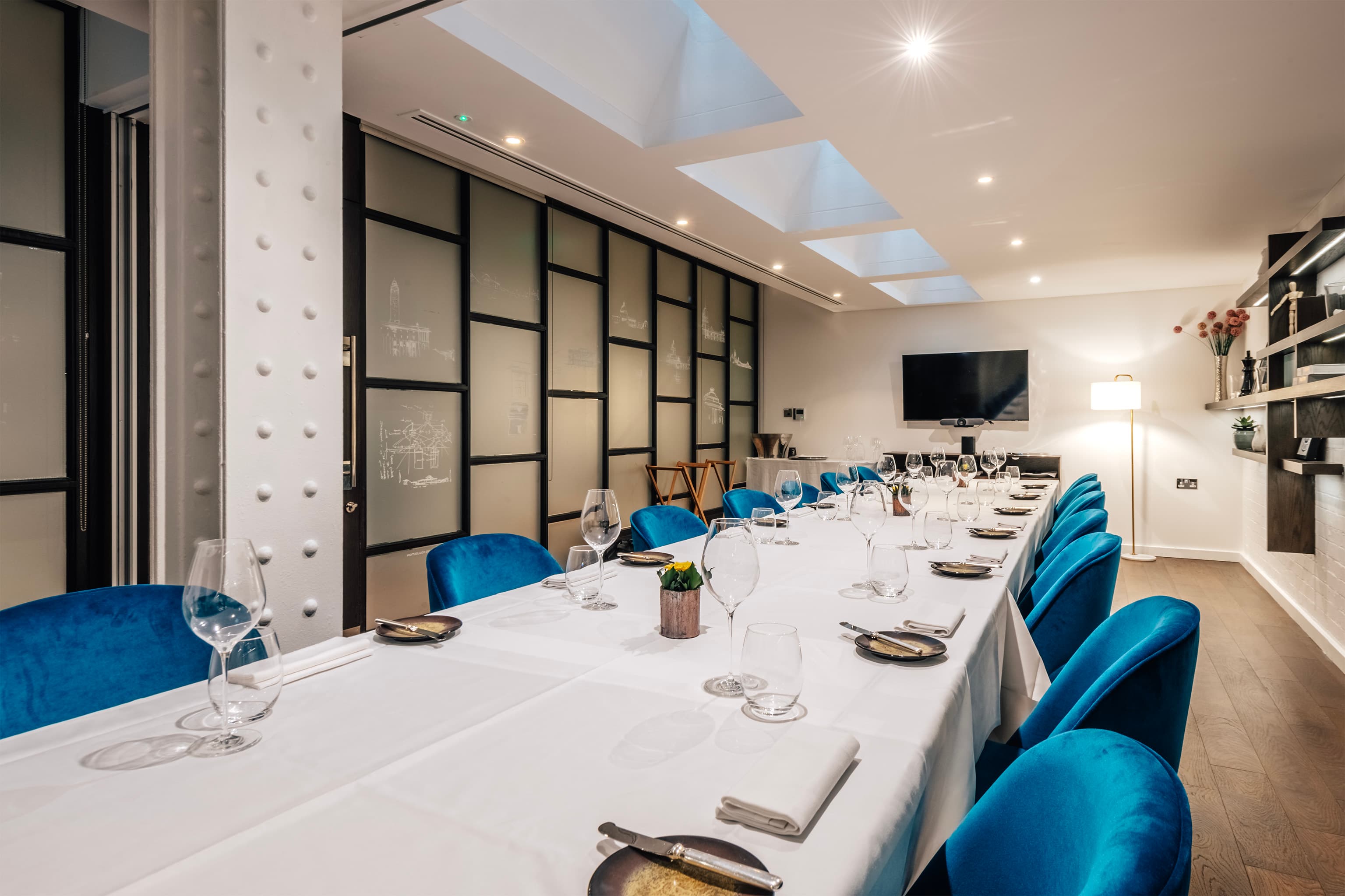 Private dining room at CORD Restaurant with blue velvet seating for corporate dinners and meetings.