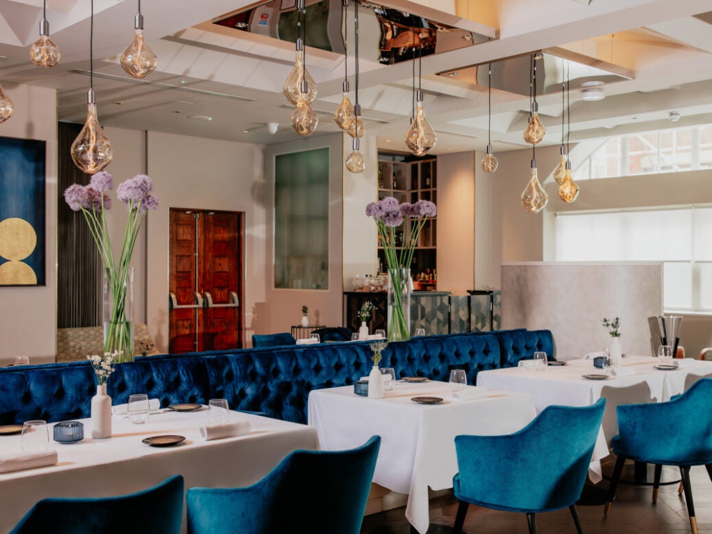 Cord Café with blue velvet banquet seating for corporate dinners and networking events.