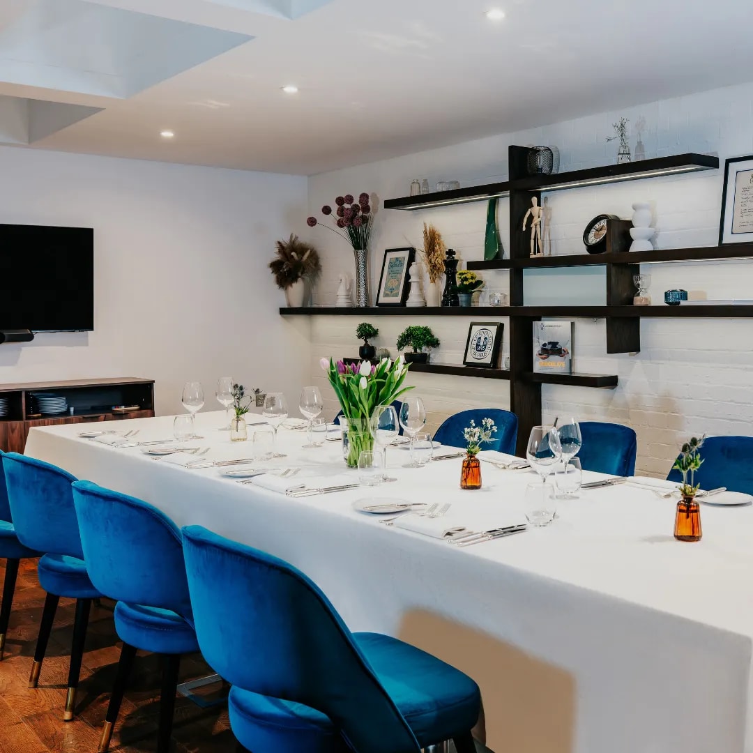 Cord Café boardroom with blue velvet chairs for high-end corporate lunches and business meetings.