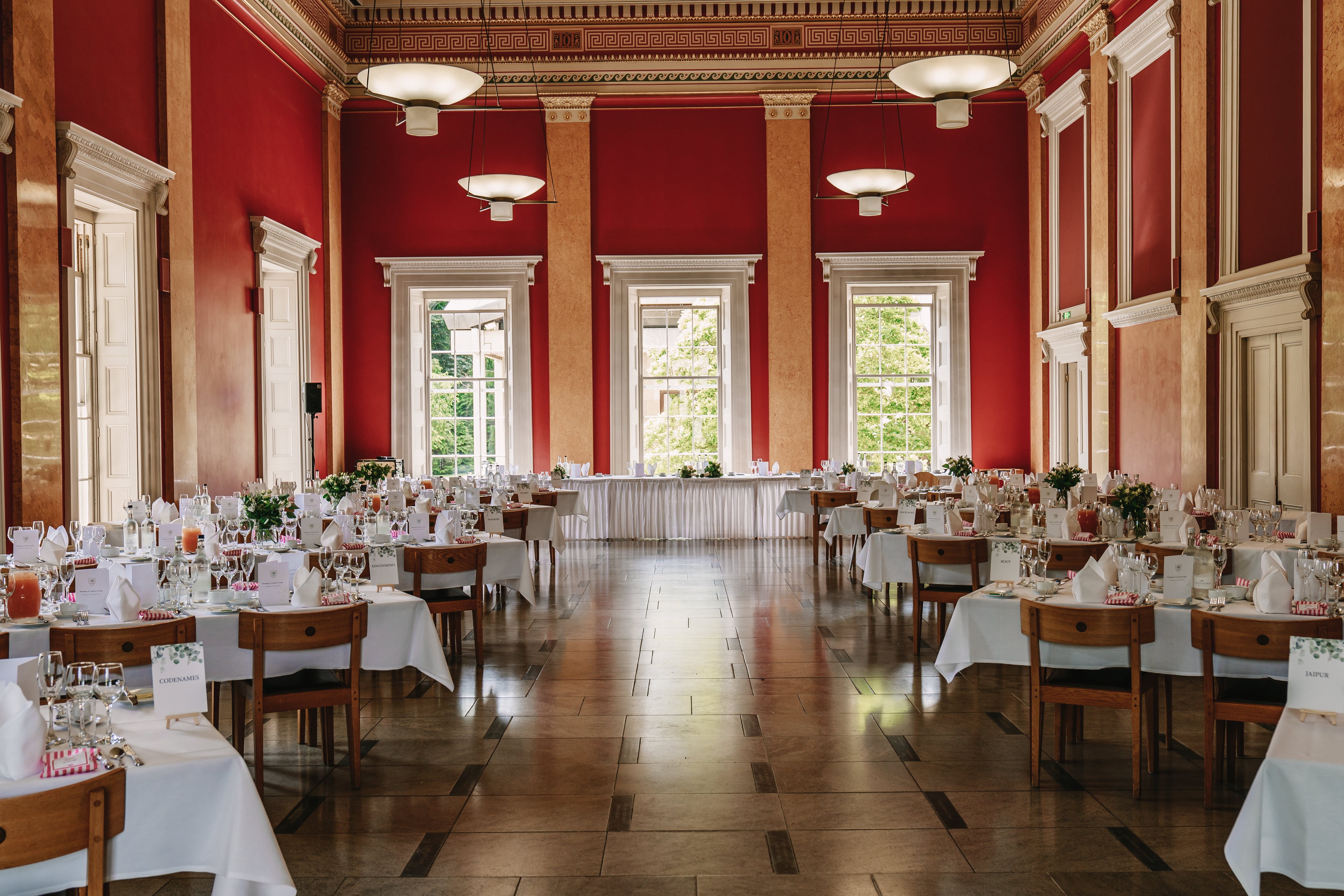 College Hall red banquet room at Downing College for formal events and wedding receptions.