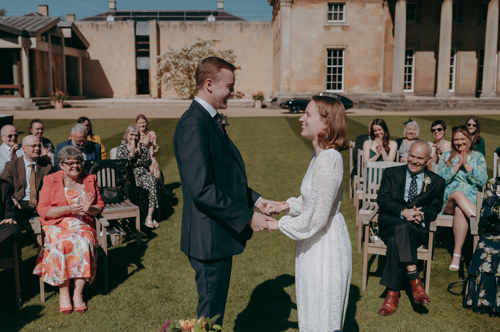 Outdoor wedding at Downing College Fellows' Garden with theater-style seating for ceremonies.