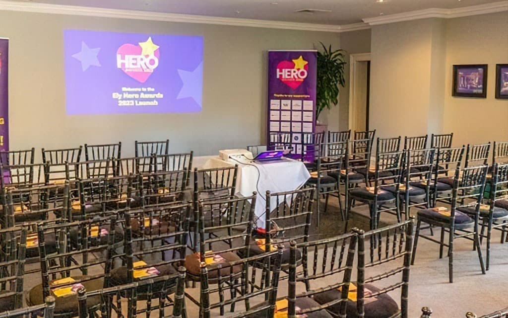 Poets House Hotel Writing Room theater setup for corporate launch event with branded signage.