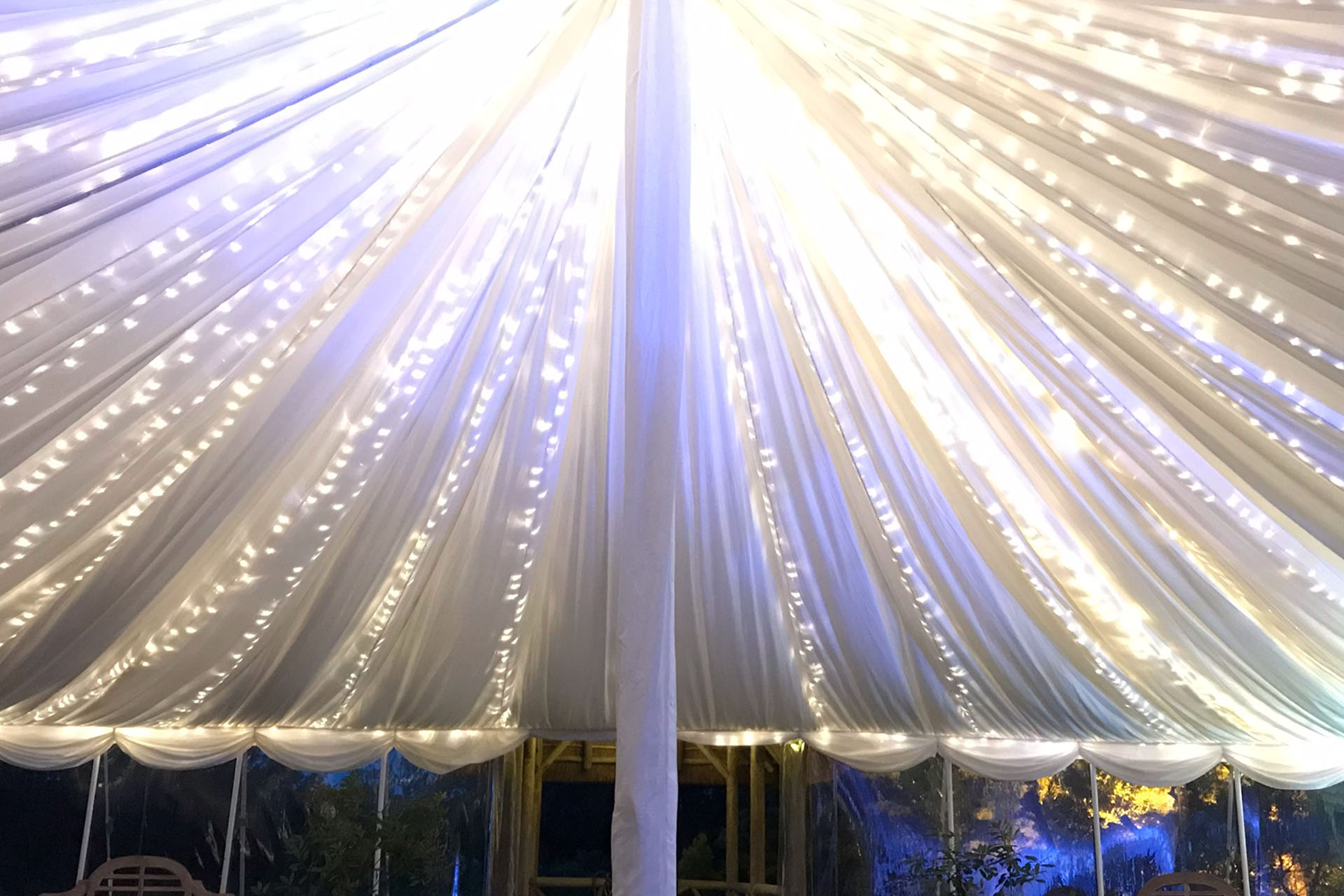 White marquee ceiling with fairy lights for elegant wedding or luxury event venue hire.