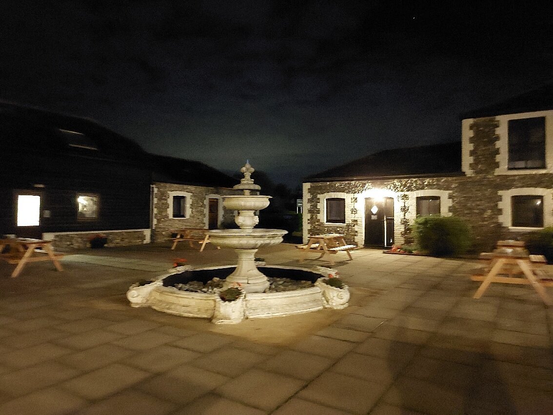 Rustic Coach House Hotel courtyard for intimate evening wedding receptions.