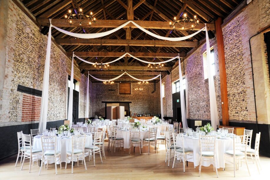 Granary Barn rustic wedding venue with elegant draping and tablescaping for luxury events.