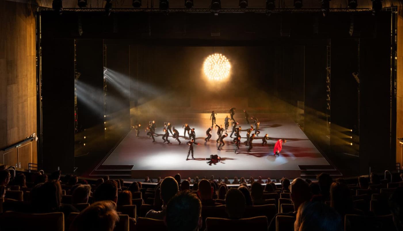 Stage production at The Hall, Aviva Studios, featuring dramatic lighting for live keynote events.