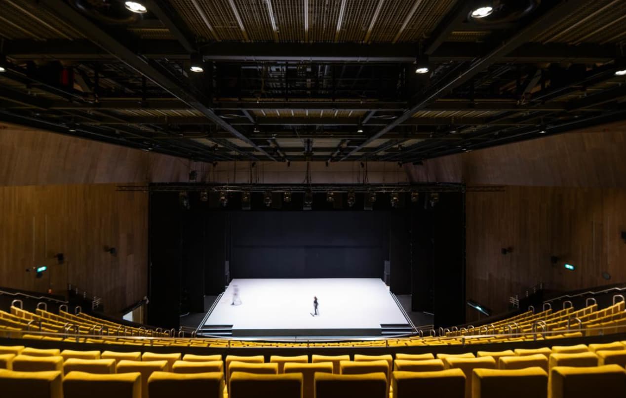 Aviva Studios Hall black-box theater with tiered seating for corporate events and keynote addresses.