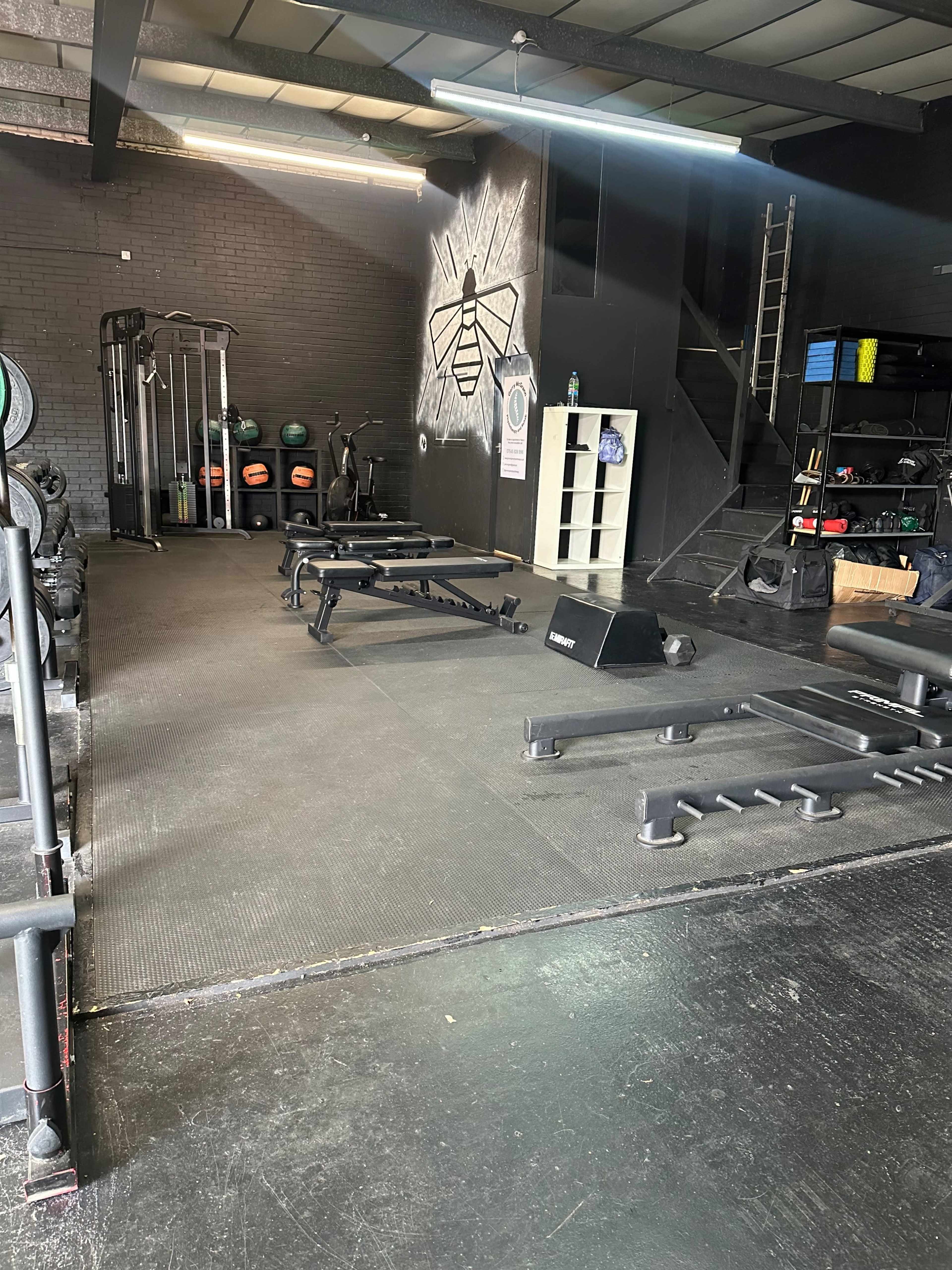Main training floor at CrossFit Ancoats featuring industrial design for fitness team-building.