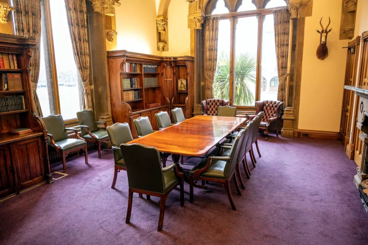 Historic boardroom with upscale decor for private strategy meetings and professional interviews.