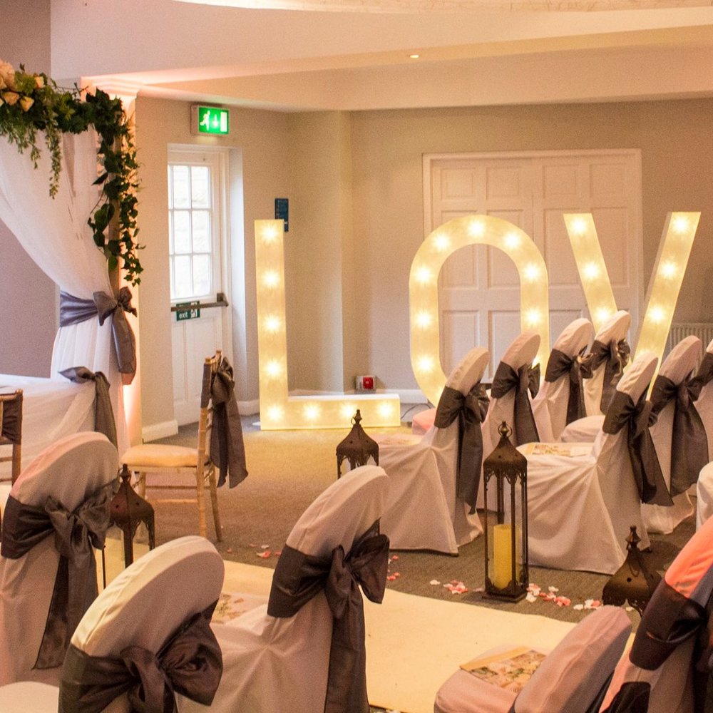 The Terminal Suite wedding ceremony with marquee lights and Chiavari chairs.