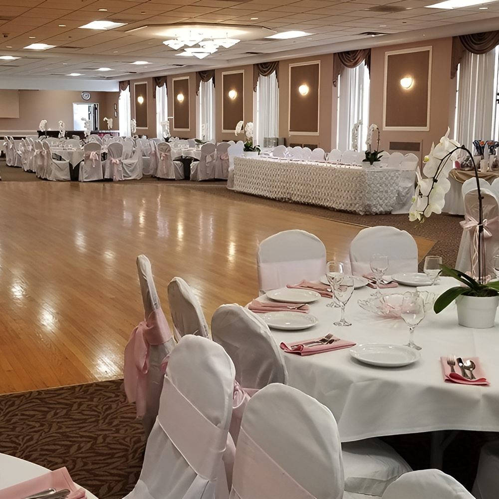 Main Hall wedding reception with banquet tables and dance floor for formal gala events.
