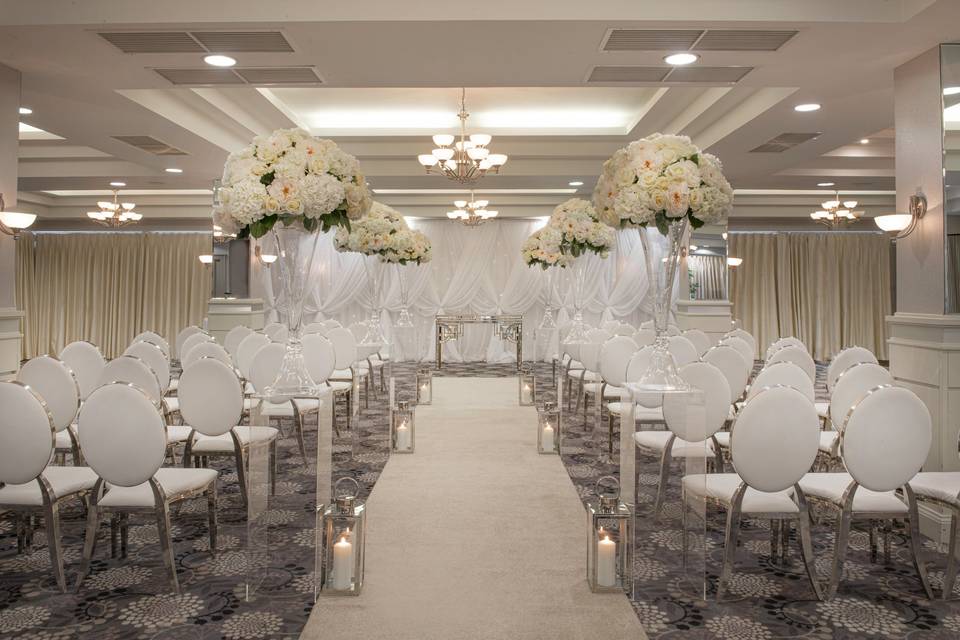 The Grand Ballroom at Crowne Plaza Belfast, wedding ceremony setup with elegant floral decor.
