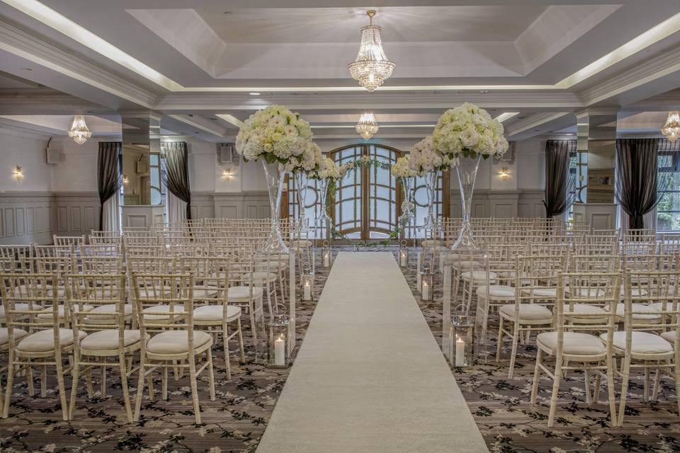 Elegant wedding ceremony setup with Chiavari chairs at Crowne Plaza Belfast ballroom.