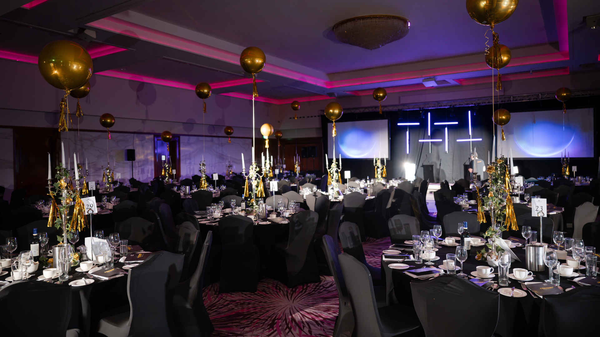 Grand Ballroom gala in Stormont Hotel with pink lighting and gold balloons for corporate events.