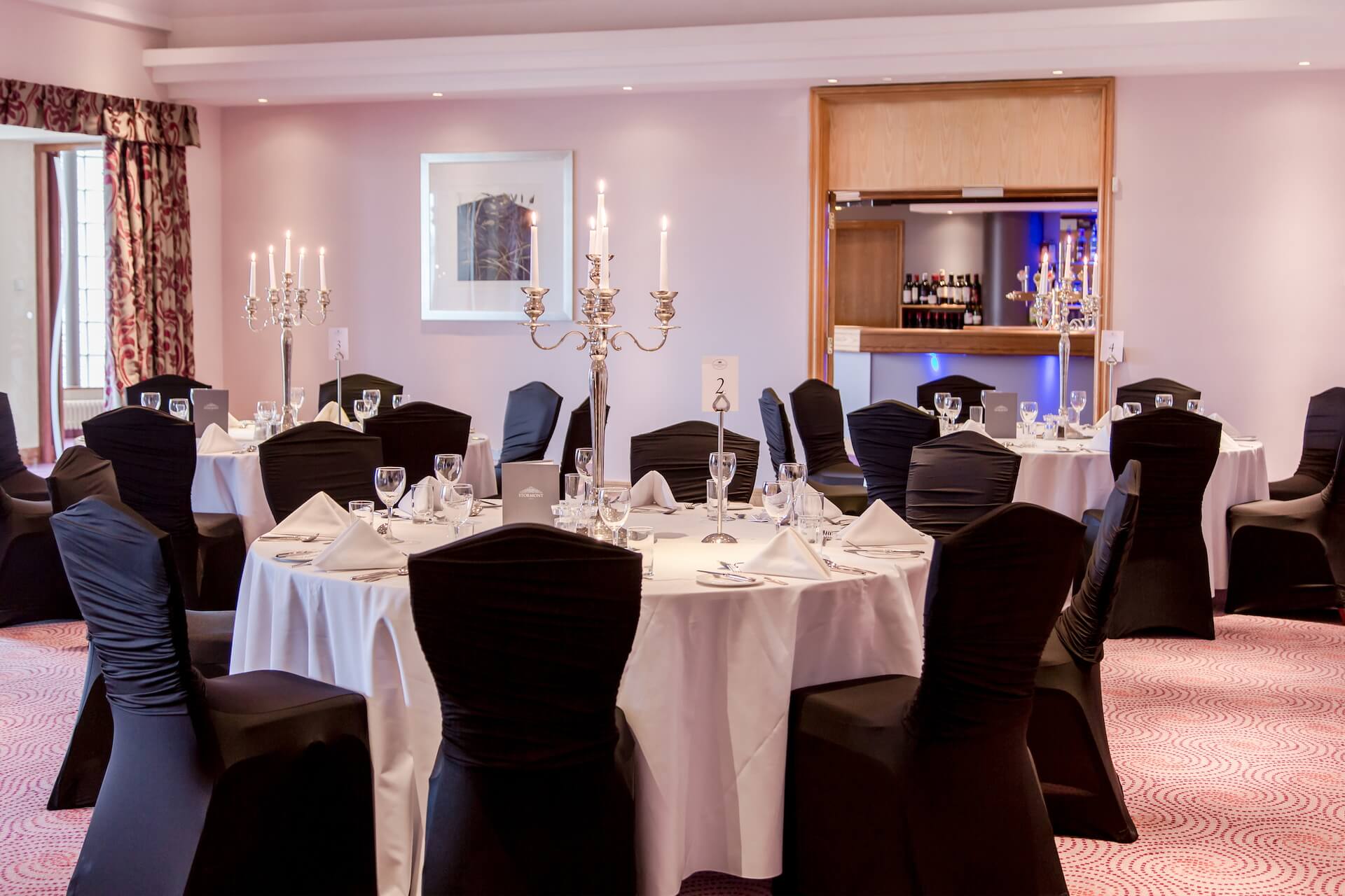 Grand Ballroom at Stormont Hotel with banquet tables, perfect for wedding and gala event venues.
