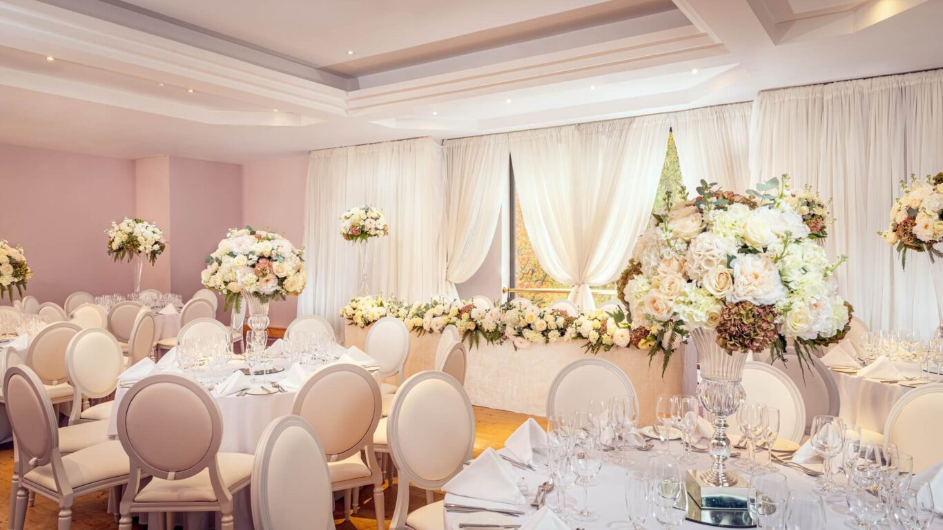 Luxury wedding reception at Dunmisk Suite, Stormont Hotel Belfast with elegant floral centerpieces.
