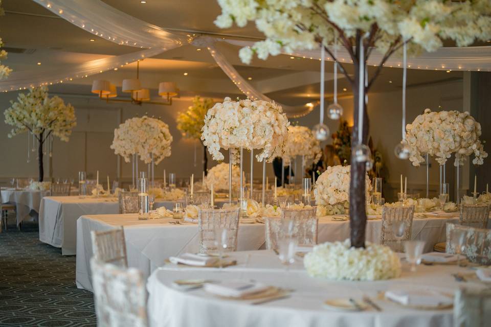 Elegant wedding reception in Stephenson Suite, De Vere Cranage Estate with cherry blossom decor.