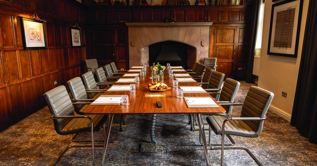 Executive boardroom at De Vere Cranage Estate with wood paneling for corporate strategy meetings.