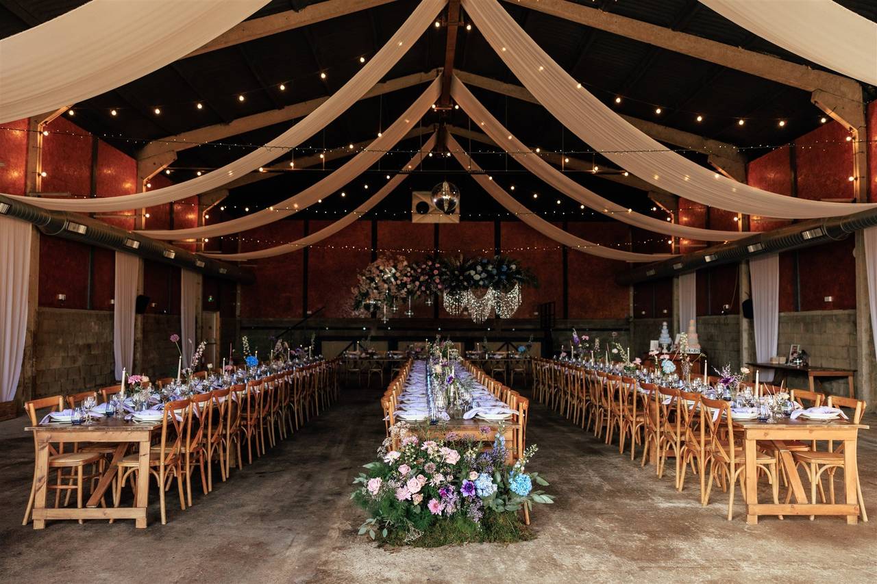 Rustic Barn Wedding Venue at The Granary with drapery and bistro lighting for elegant events.