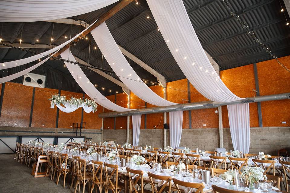 The Granary at Lodge Farm featuring elegant drape and lighting for luxury wedding venue events.
